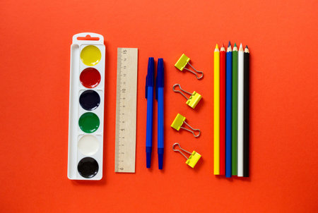 Back to school flat lay. Set of stationery on a red background, top view.
