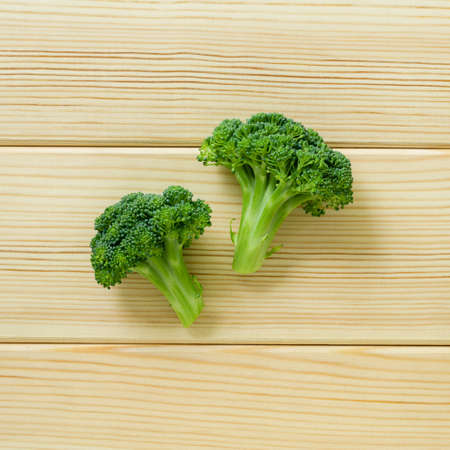 Fresh broccoli cabbage on a light wooden background, top viewの写真素材