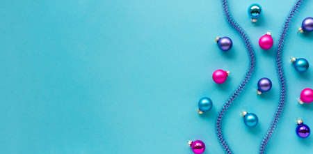 Christmas or new year composition with multicolored balls and tinsel on a blue background. Space for text.の写真素材