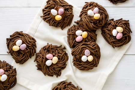 Easter chocolate cookies. Nests with sweet eggs on white background