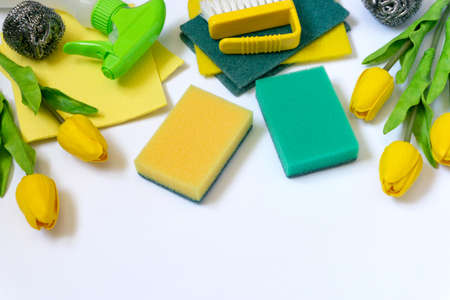 Spring cleaning Items with yellow tulips on white backgroundの写真素材
