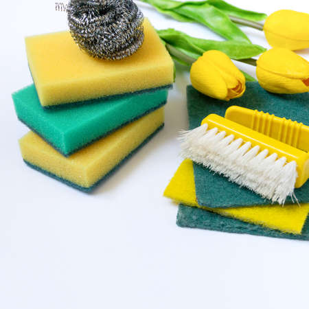 Spring cleaning Items with yellow tulips on white backgroundの写真素材