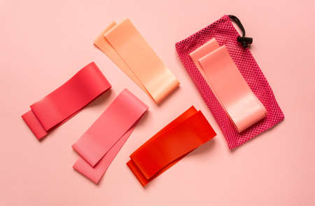 Flat lay of pink fitness bands on colored background, top viewの写真素材
