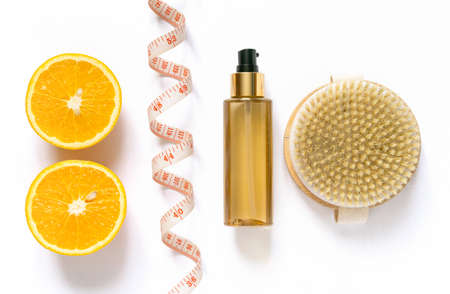 Anti-cellulite care products. Brush for dry massage and oil on white background, top view.の写真素材