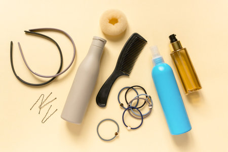 Flat lay of accessories and hair care products on beige background, top viewの写真素材