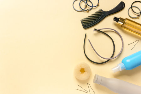 Flat lay of accessories and hair care products on beige background. Space for textの写真素材