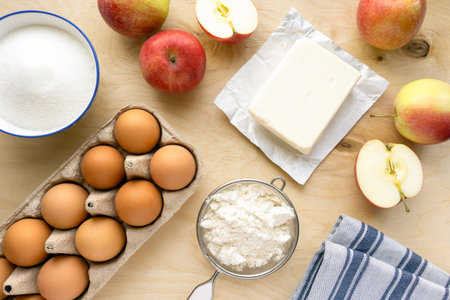 Bakery flat lay. Ingredients for cooking apple pie on wooden background, top viewの写真素材