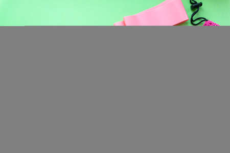 Flat lay of elastic bands for fitness on green background, copyspaceの写真素材