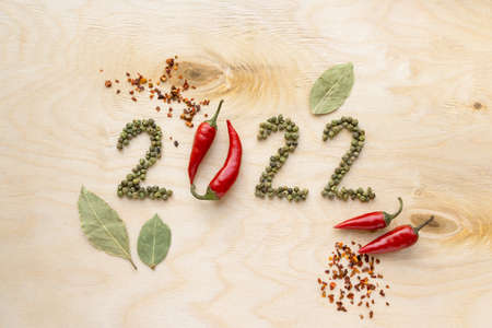 New year and christmas concept. Text 2022 made of pepper on wooden background, top viewの写真素材