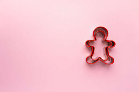 Christmas cookie cutters in the shape of man on pink background, space for textの写真素材