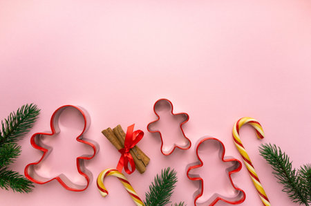 Christmas cookie cutters in the shape of man on pink background, space for text