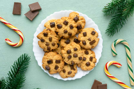 Christmas cookies with chocolate chips on blue textile background, top viewの写真素材