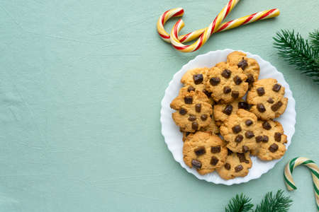 Christmas cookies with chocolate chips on blue textile background, space for textの写真素材