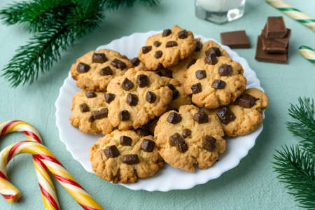 Christmas cookies with chocolate chips on blue textile backgroundの写真素材