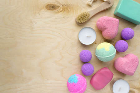 Set of spa products. Soap, bath bombs and candles on wooden background, space for textの写真素材