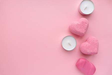 Valentines day flat lay. Bath bombs, soap and candles on pink background, space for textの写真素材