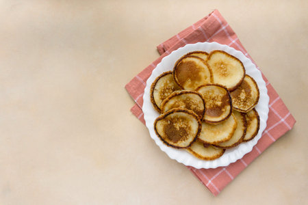 Fried pancakes on beige background, space for textの写真素材