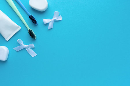 Flat lay of oral care products. Toothbrush, dental floss and paste on blue background, space for textの写真素材