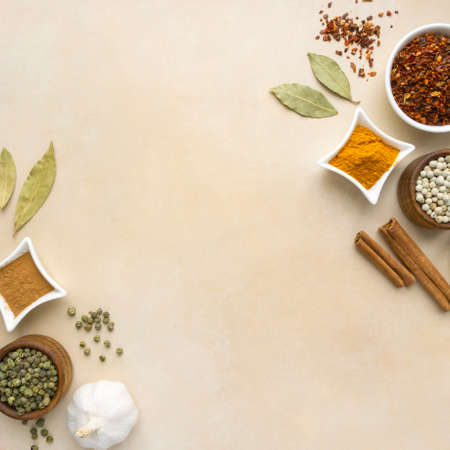 Flat lay of spices and seasonings on beige backgroundの写真素材