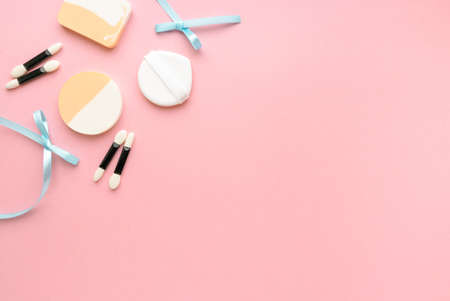 Makeup sponges and eyeshadow applicators on pink background, space for textの写真素材