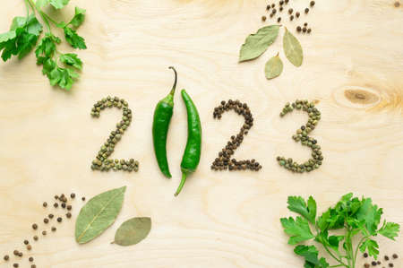 New year and christmas concept. Text 2023 made of pepper on wooden background, top viewの写真素材