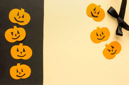 Greeting card for halloween. Paper pumpkins on beige and black background, copyspaceの写真素材