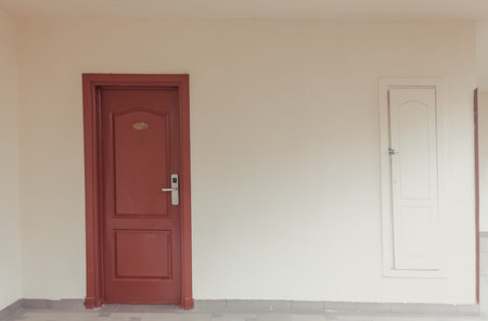 Old hotel room door. Empty hall of an Egyptian hotel. The cleaning room little door is nearby.