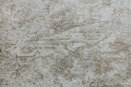 A grey weathered wall. Abstract background with cracks and scratches. Old cement wall with beautiful grunge texture.の写真素材