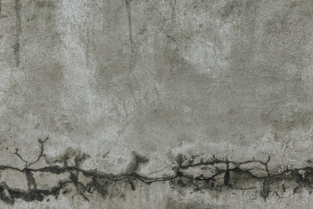 A cracked concrete wall texture with scratches. An old grey cement wall background.