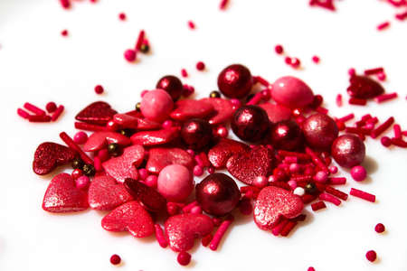 Many small white and red hearts on a white isolated background. The concept of love and romance. Romantic background composition. Valentines Dayの写真素材