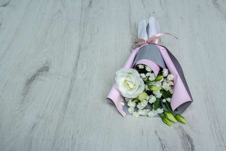A bouquet of flowers on a white wooden background. mother's day. International Women's Day. The concept of the holiday.の写真素材