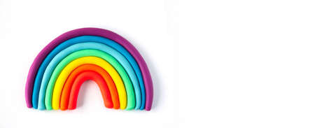 Banner of a colorful rainbow of plasticine on white background. Made from plasticine. Isolate.の写真素材