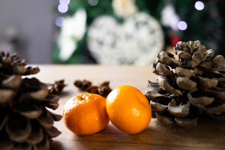 Christmas decorations, tangerines, and spices lie on a wooden background. The concept of the New Year and Christmas time.の写真素材