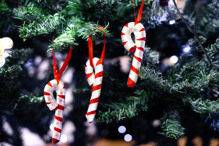 Toy candies made of felt hang on the Christmas tree. New Years decorations on a Christmas tree. The...