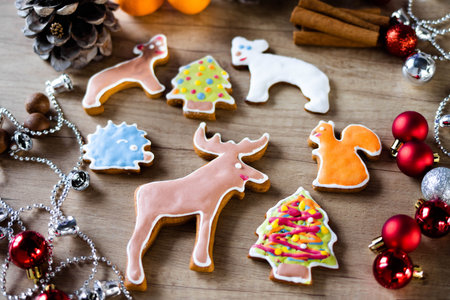 Childrens hands take Christmas ginger cookies from the table with Christmas spices and decorations....