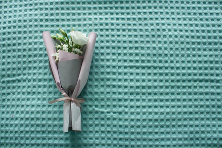 A bouquet of flowers on a turquoise background. Mothers Day. International Womens Day. The concept...