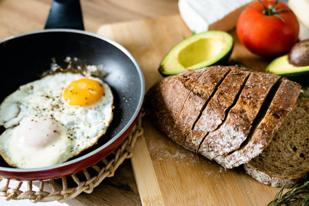 Traditional breakfast of scrambled eggs and toast. Cooking concept.