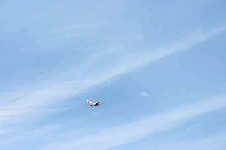 A small plane in the sky with space for text. Single plane flies lonely in the clear blue sky....