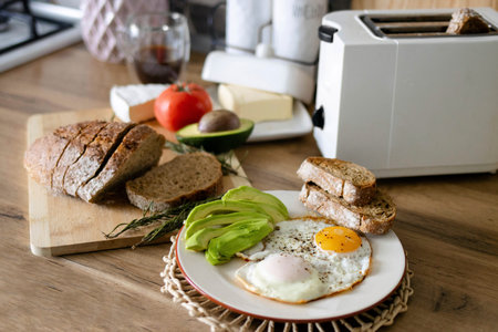 Traditional breakfast of scrambled eggs and toast. Cooking concept.