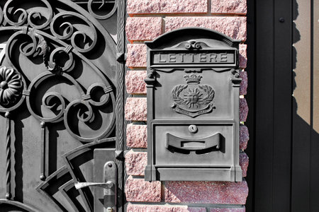 Black metal mailbox outdoors close-up. Old and beautiful vintage mailbox. Space for text.の写真素材