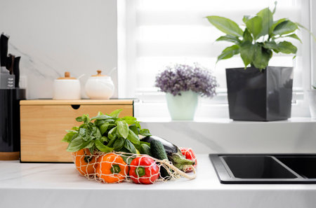 Fresh vegetables and fruits in a reusable bag in the modern kitchen. Concept of healthy nutrition and organic food. Grocery shopping. Zero Waste. Eco-Friendly Shopping. The idea of a healthy lifestyle.の写真素材