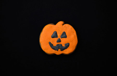 Halloween gingerbread cookies on a dark background. Bright homemade cookies for Halloween party....