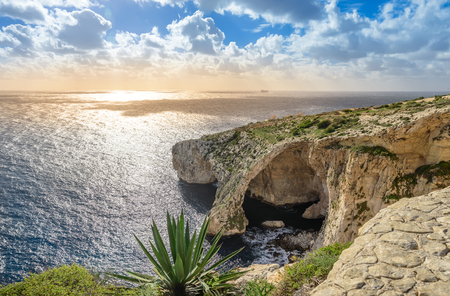 Blue Grotto, Malta. Natural stone arch and sea caves and agave plant in foreground. Phantastic sea view on Malta island.の写真素材