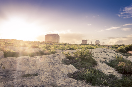 Saint Mary Magdalene Chapel and Aviation radar unter the light of setting sun near Dingli Cliffs, Malta in romantic purple toneの写真素材