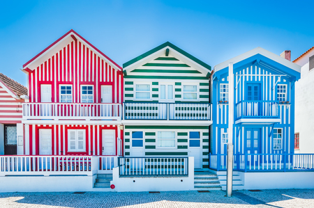 Costa Nova, Portugal: colorful striped houses called Palheiros with red, blue and green stripes. Costa Nova do Prado is a beach village resort on Atlantic coast near Aveiro.の写真素材