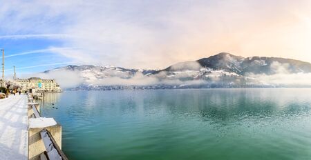 Zell am See, Austria - Dec 2019: Lake Zell in the Austrian Alps in winter. Panoramic view of lake, foggy mountains and Esplanade leading to Grand Hotel in the alpine town Zell am Seeのeditorial素材