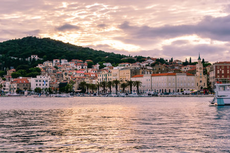 Split, Croatia - May 21, 2019: old town with colorful buildings, Riva Promenade with palm trees and Marjan hill. Vivid waterfront evening view at sunset. Popular touristic destinationのeditorial素材