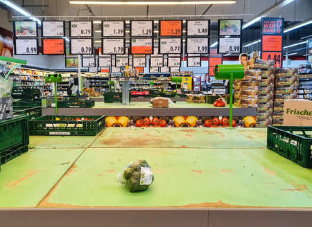FULDA, GERMANY - MAR 14, 2020: Empty shelves for vegetables with single broccoli at Kaufland supermarket due to Coronavirus crisis. Panic buying leads to food supply shortage in german grocery stores.のeditorial素材