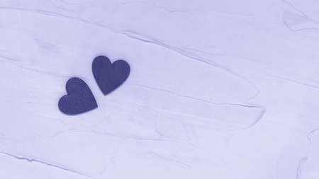 Two wooden hearts on textured background toned in trendy Very Peri color of the year 2022 from above. Love and togetherness, Valentines Day. Purple or violet flat lay with copy space for textの写真素材