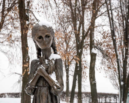 Kyiv, Ukraine - JAN 2019: Close-up of child holding spikelet monument in front of National Museum of Holodomor Genocide also known as Memorial in Commemoration of famine victims of 1923-1933 yearsのeditorial素材